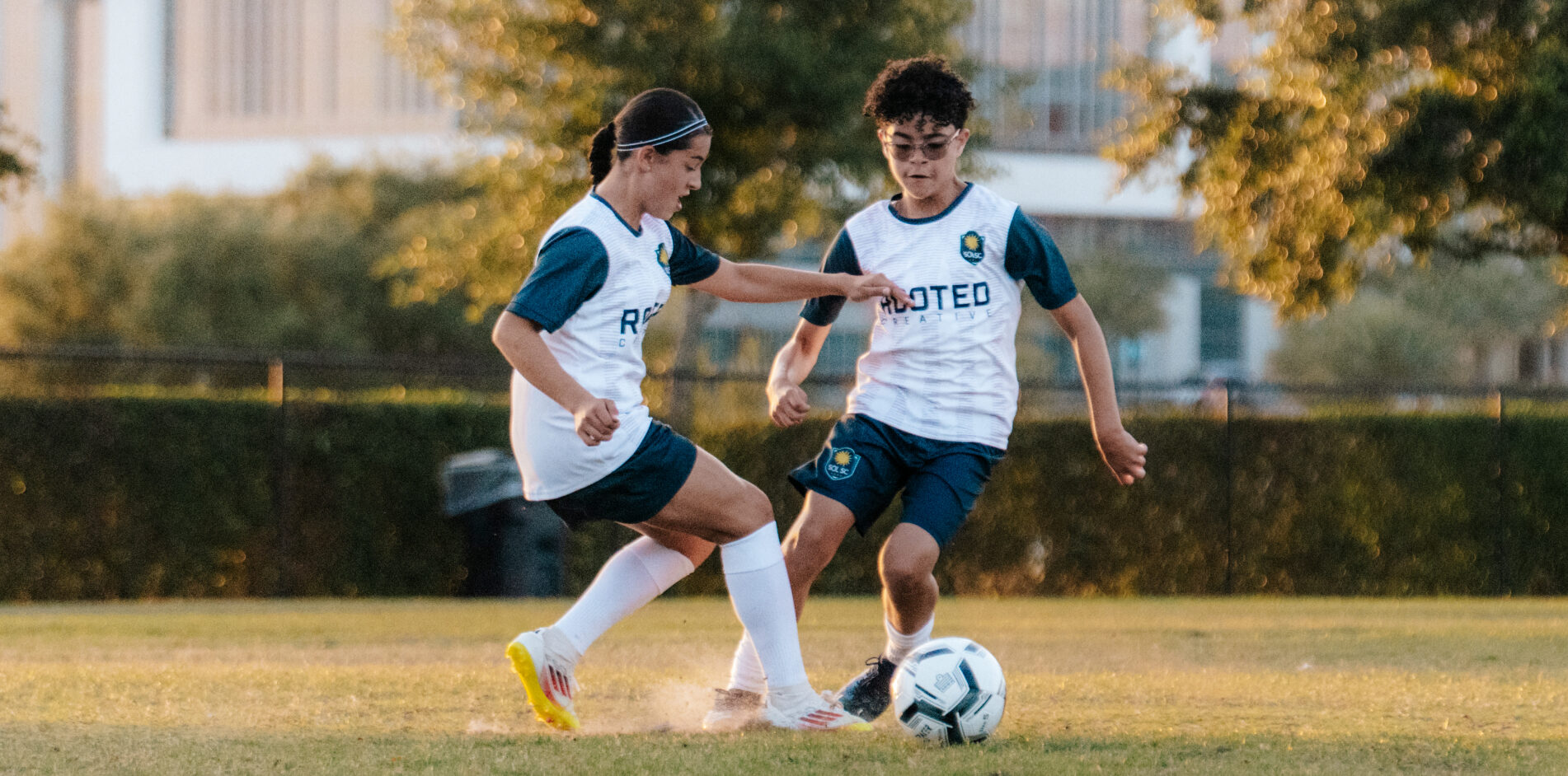 Young Sol SC players competing for the ball
